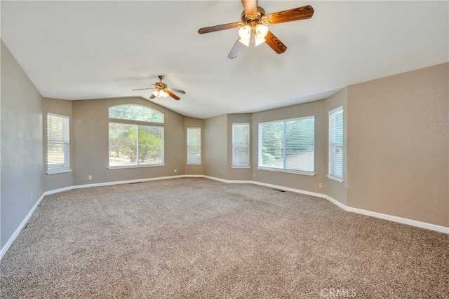 carpeted empty room with ceiling fan and lofted ceiling