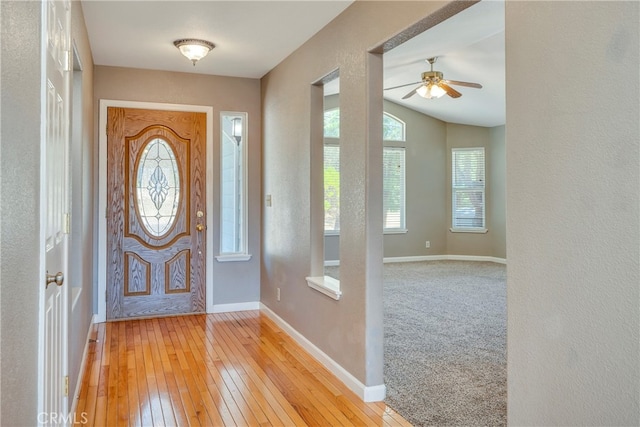 entrance foyer featuring ceiling fan, light hardwood / wood-style flooring, and lofted ceiling