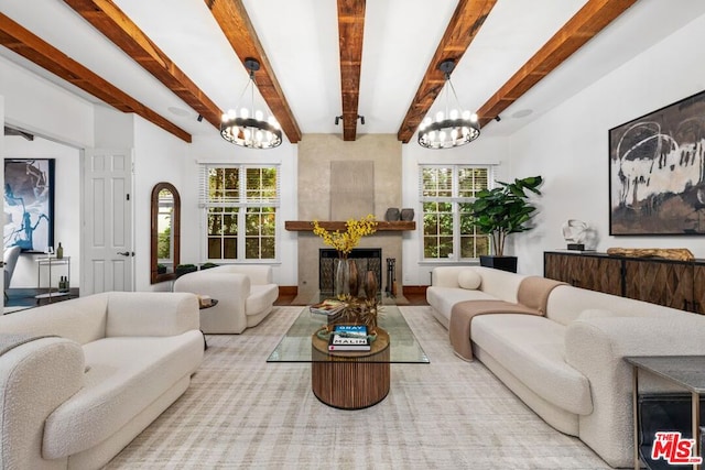 living room with a notable chandelier, a wealth of natural light, and beam ceiling