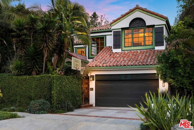 mediterranean / spanish house featuring a garage