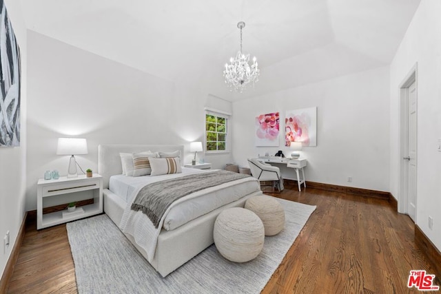 bedroom featuring vaulted ceiling, a chandelier, and dark hardwood / wood-style flooring