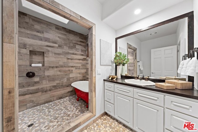 bathroom featuring shower with separate bathtub, tile patterned floors, vanity, and wooden walls