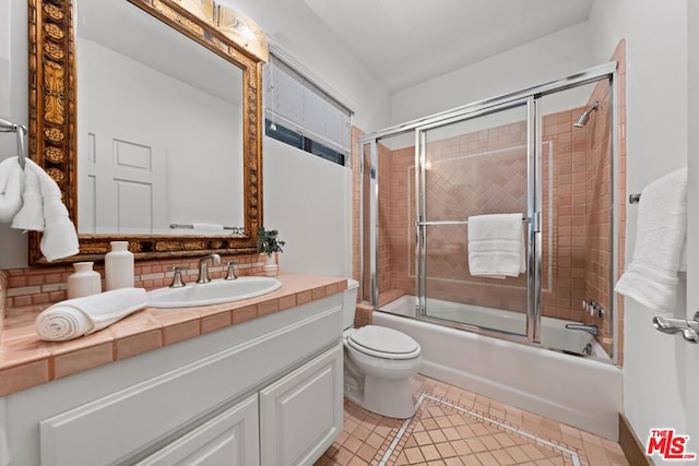 full bathroom with backsplash, combined bath / shower with glass door, vanity, and toilet