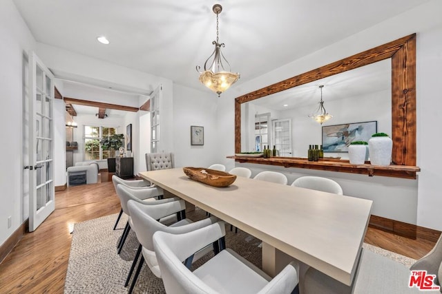 dining room with french doors and light hardwood / wood-style floors