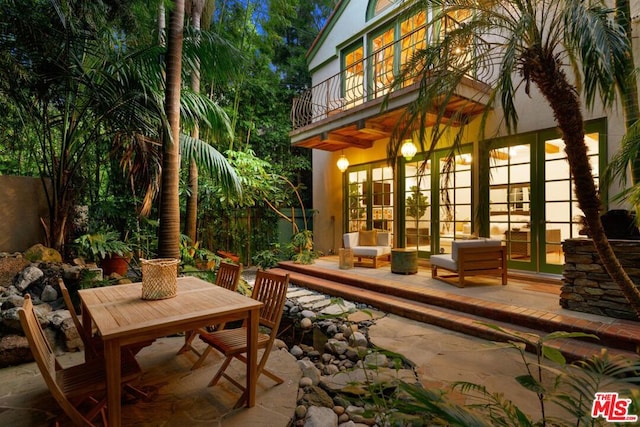 view of patio with outdoor lounge area and a balcony