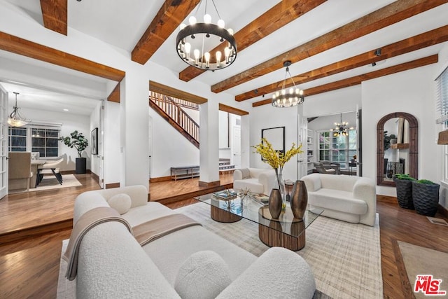 living room with wood-type flooring, beam ceiling, and an inviting chandelier