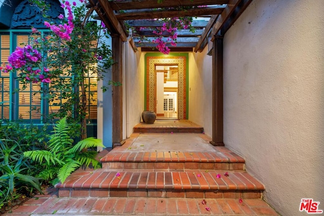 entrance to property featuring a pergola and a porch