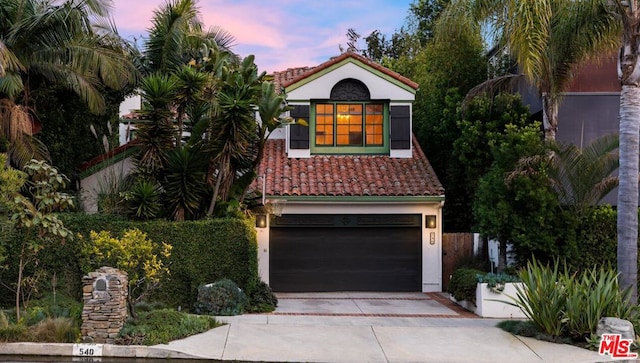 mediterranean / spanish-style home featuring a garage