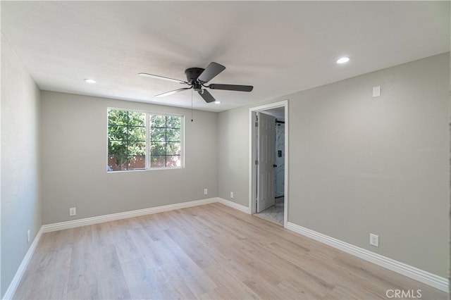 empty room featuring ceiling fan and light hardwood / wood-style flooring