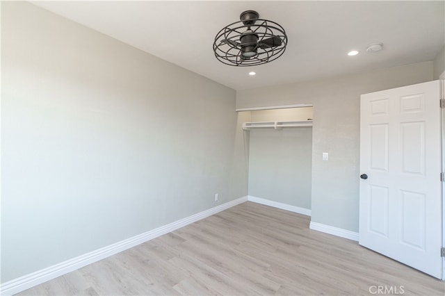 unfurnished bedroom with light hardwood / wood-style flooring and a closet