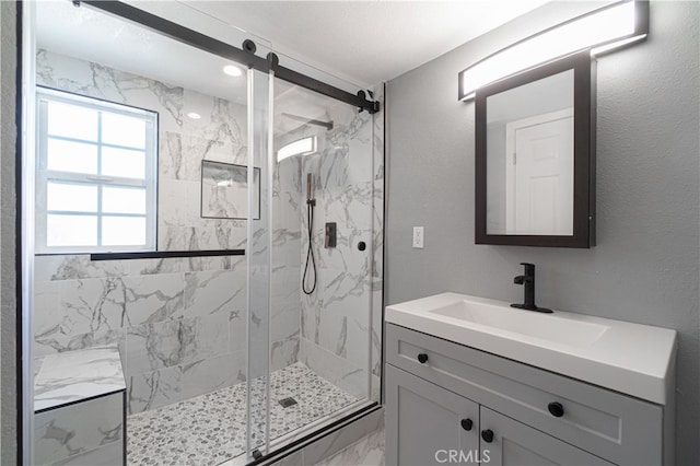 bathroom with vanity and a shower with shower door