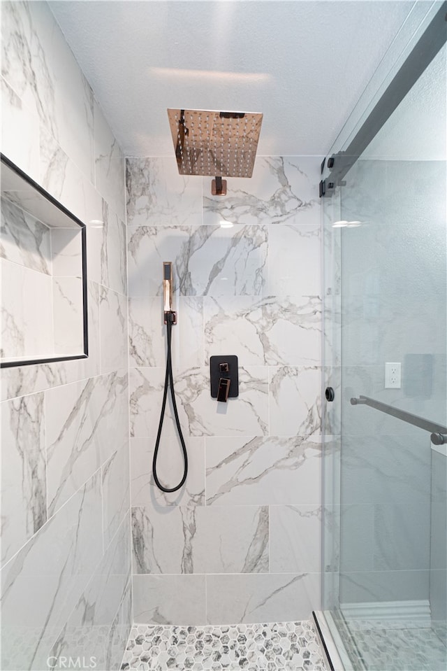 bathroom with tiled shower