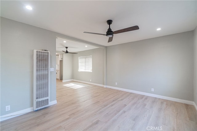 spare room featuring ceiling fan and light hardwood / wood-style flooring