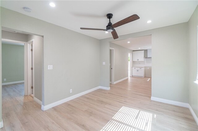 empty room featuring ceiling fan and light hardwood / wood-style floors