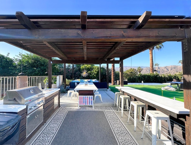 view of terrace with outdoor lounge area, a pergola, exterior bar, and grilling area