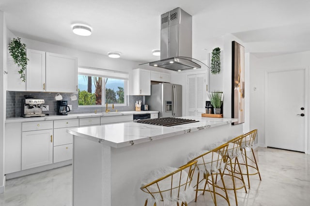 kitchen featuring island exhaust hood, stainless steel appliances, white cabinets, and sink