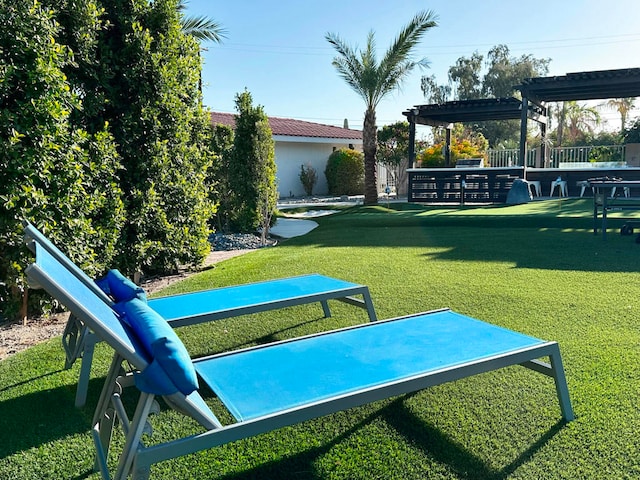 view of property's community with a pergola and a yard