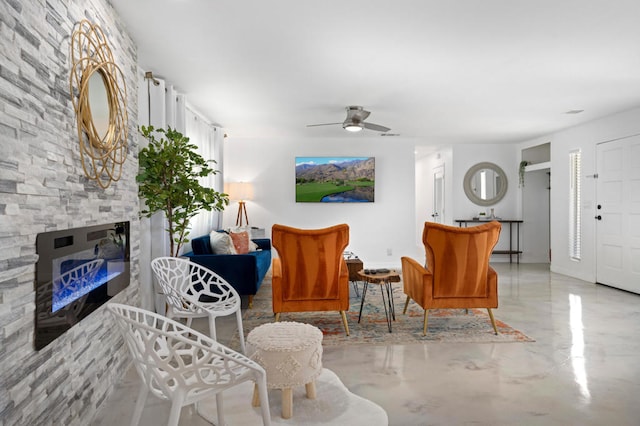 living room featuring a fireplace and ceiling fan