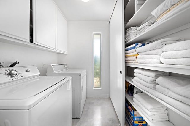 laundry room featuring cabinets and washing machine and dryer