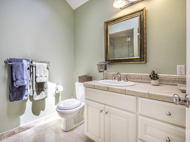 bathroom with toilet, vanity, walk in shower, and tile patterned flooring