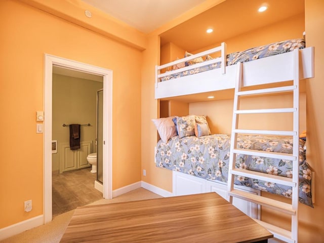 carpeted bedroom featuring ensuite bathroom