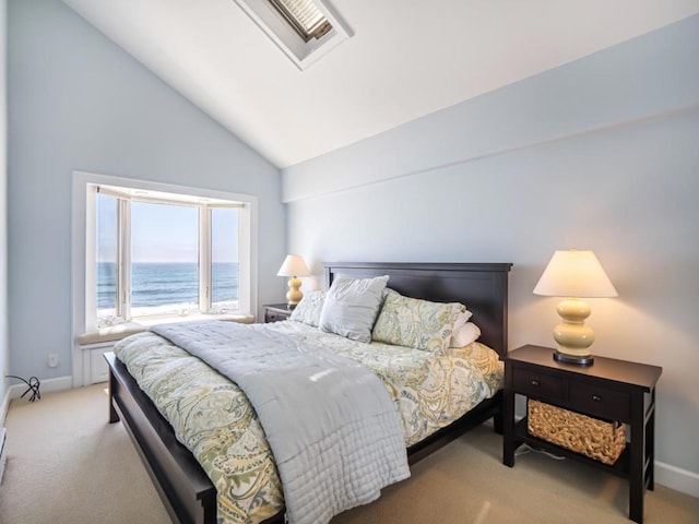 bedroom with lofted ceiling, light carpet, and a water view