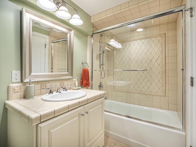 bathroom featuring shower / bath combination with glass door, vanity, and tile patterned flooring