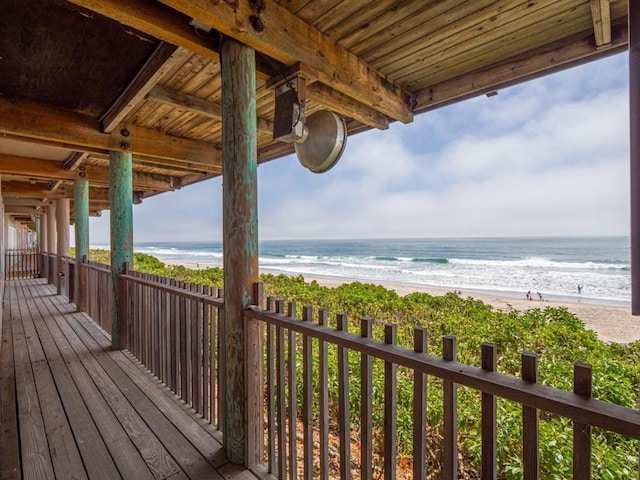 deck with a water view and a view of the beach