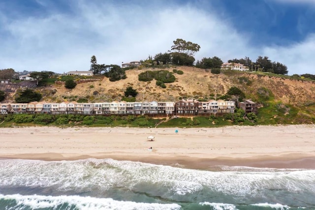 exterior space with a water view and a beach view