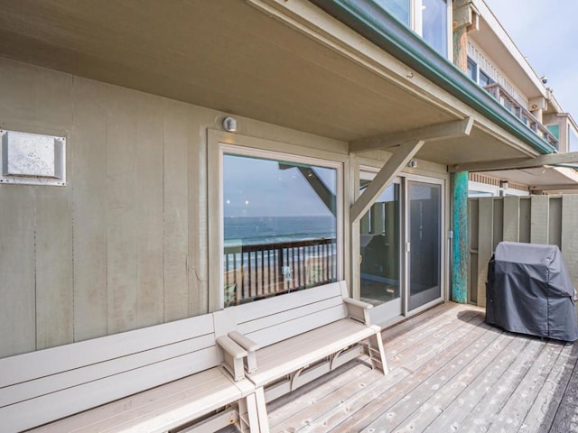 deck featuring area for grilling and a water view