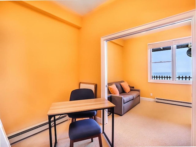 home office featuring a baseboard heating unit, carpet, and a water view