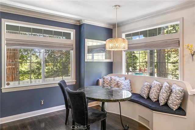 dining area with dark hardwood / wood-style floors and crown molding