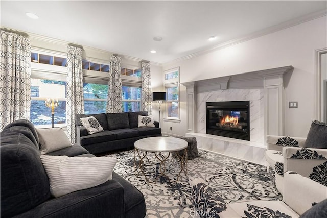 living room featuring a premium fireplace and ornamental molding