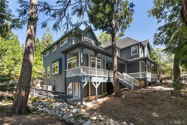 rear view of house featuring covered porch