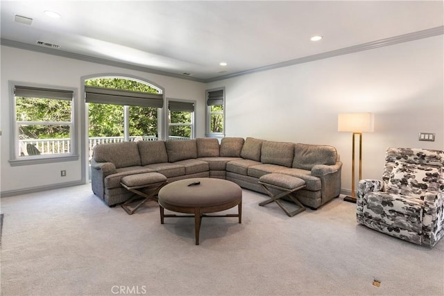 living room featuring plenty of natural light, light colored carpet, and ornamental molding