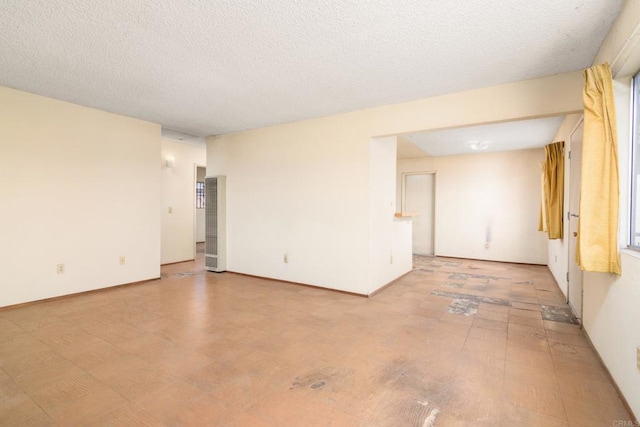 unfurnished room featuring a textured ceiling