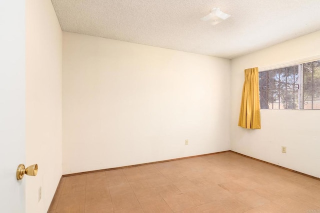 spare room featuring a textured ceiling