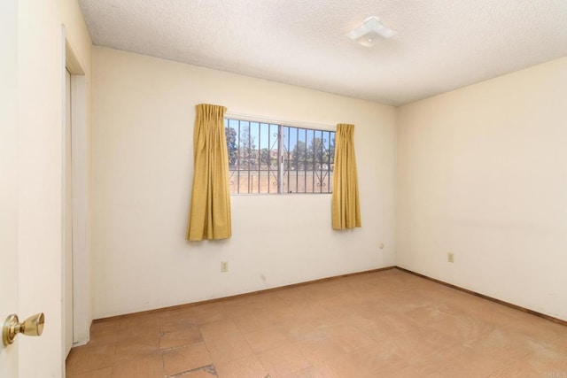 spare room with a textured ceiling