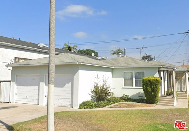 view of side of property with a yard and a garage