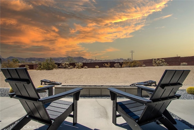 patio terrace at dusk with a mountain view