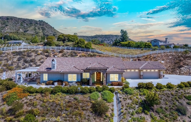 view of front of property featuring a mountain view and a garage