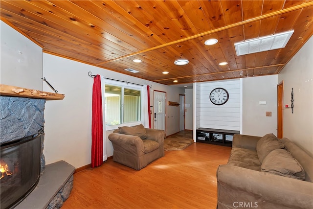 living room featuring hardwood / wood-style flooring, a fireplace, and wooden ceiling