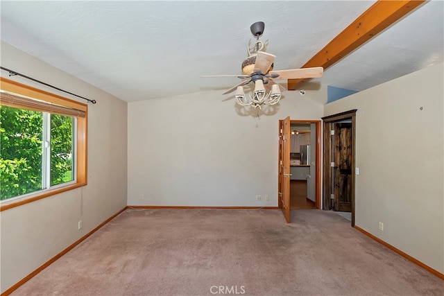 carpeted spare room with vaulted ceiling with beams and ceiling fan