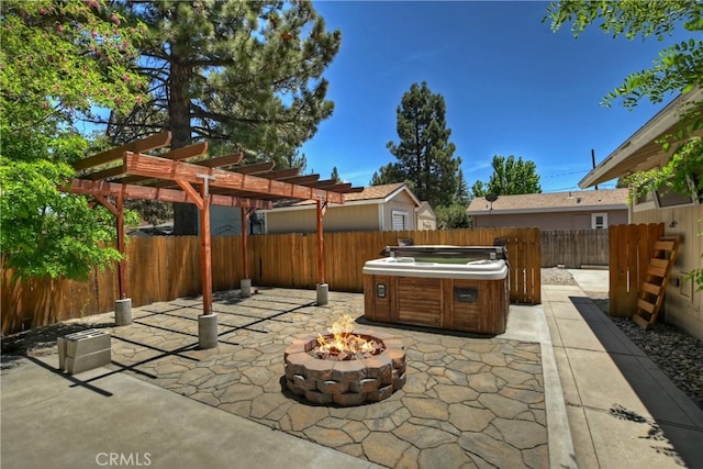 view of patio / terrace with a pergola, a hot tub, and an outdoor fire pit