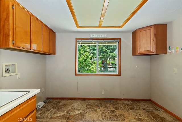 washroom with hookup for a washing machine and cabinets