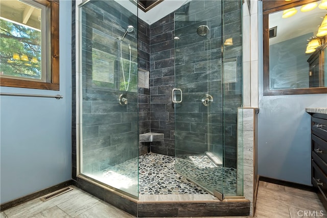 bathroom featuring walk in shower and vanity