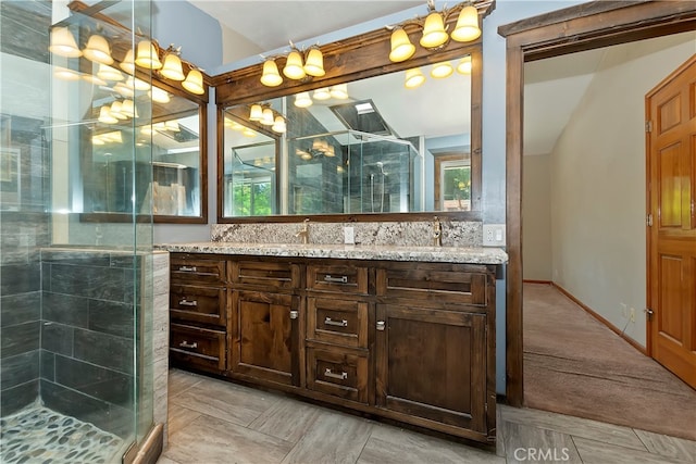 bathroom featuring walk in shower and vanity