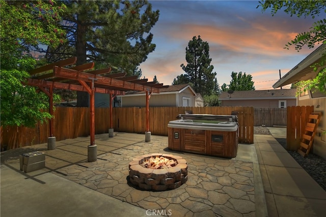 patio terrace at dusk featuring a hot tub, a pergola, and a fire pit