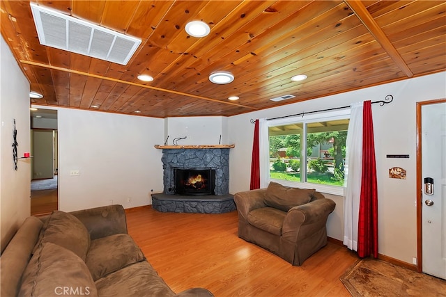 living room with light hardwood / wood-style flooring, wooden ceiling, and a fireplace