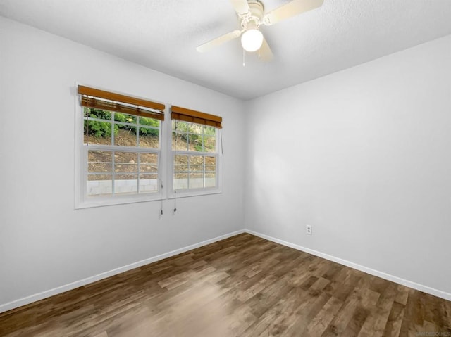 spare room with hardwood / wood-style floors and ceiling fan